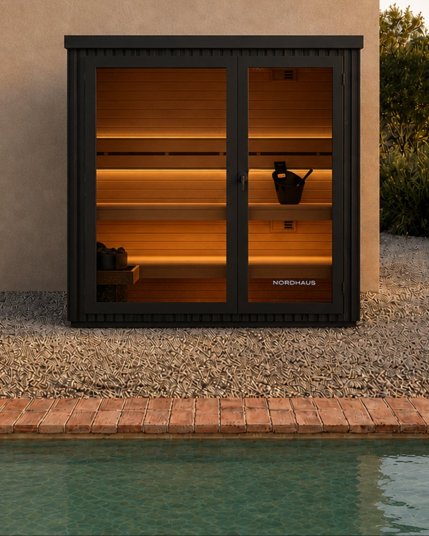 outdoor sauna with glass doors by a poolside