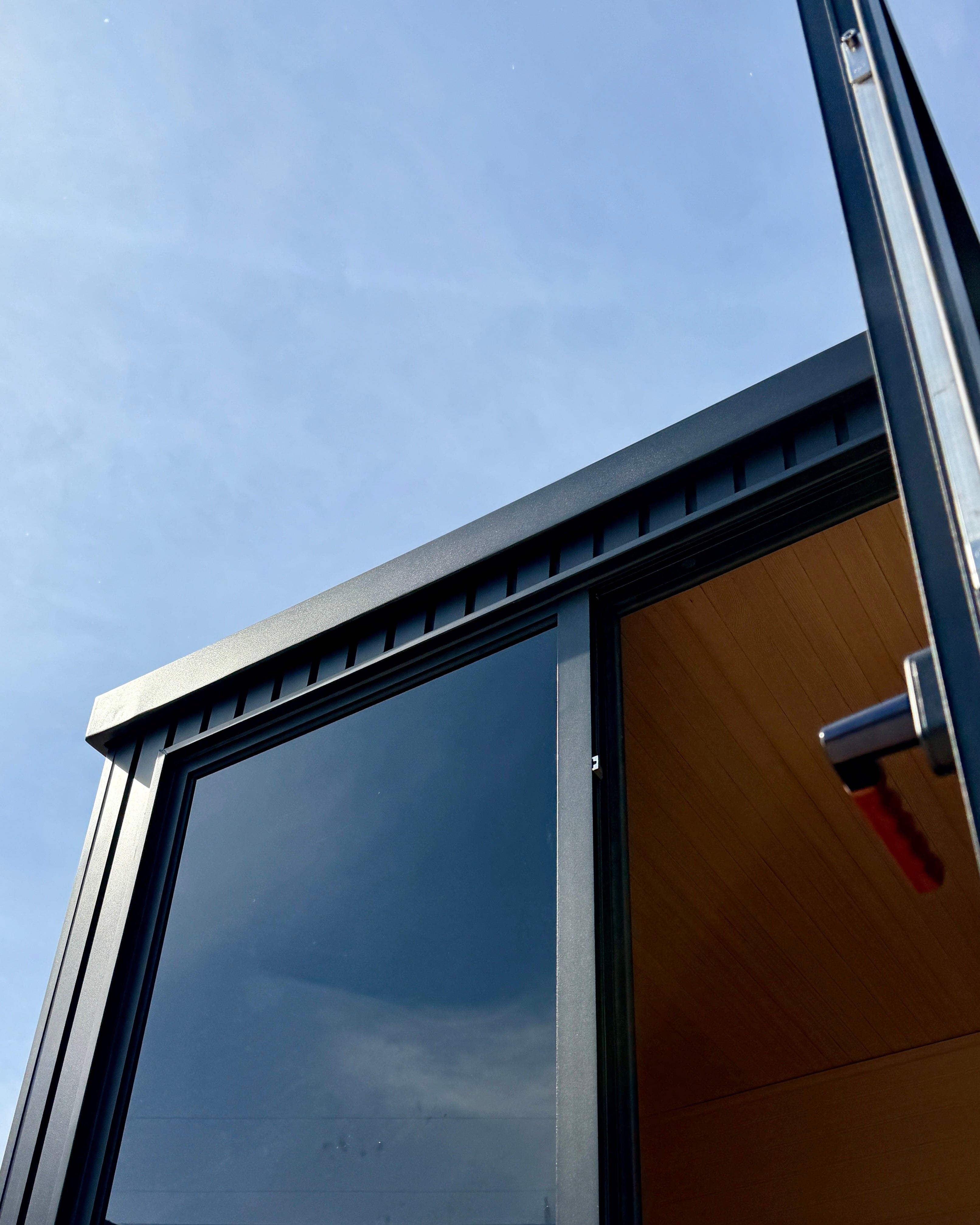 Nordhaus Outdoor Traditional Sauna with black aluminium batten cladding, tinted glass door and premium Canadian Hemlock interior designed for high-heat outdoor sauna sessions in Australian conditions.