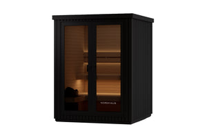 Nordhaus outdoor sauna cabinet in black with glass doors, illuminated from within to show wooden interior shelves and sauna benches.