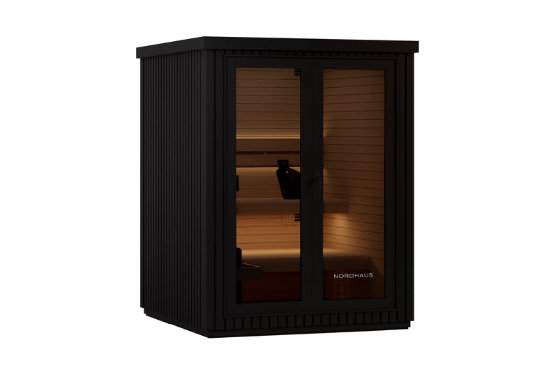 Black outdoor traditional sauna with matte aluminium cladding, warm timber interior, tiered benches, LED lighting and a full glass front door.