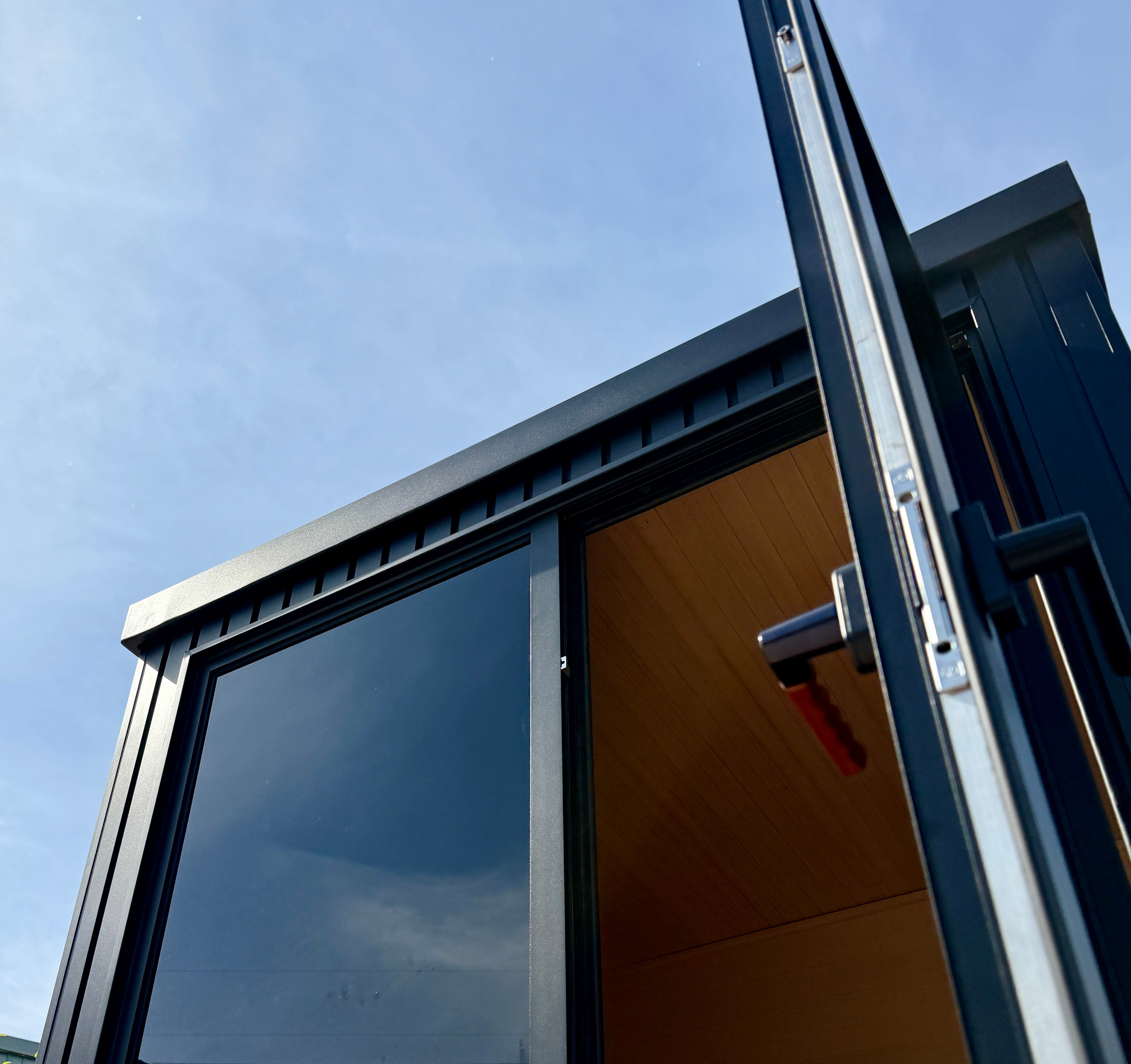 Nordhaus Outdoor Traditional Sauna with black aluminium batten cladding, tinted glass door and premium Canadian Hemlock interior designed for high-heat outdoor sauna sessions in Australian conditions.