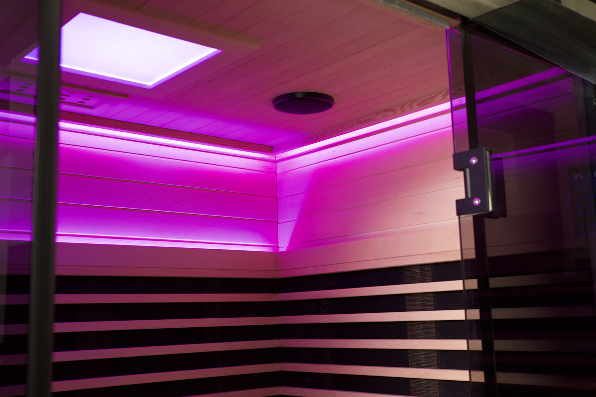 Infrared sauna with purple LED lighting and wooden interior.