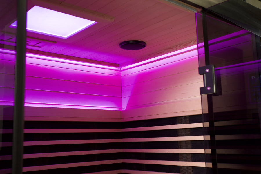 Infrared sauna with purple LED lighting and wooden interior.